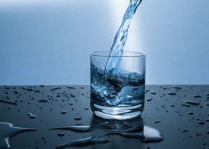 pouring water into glass