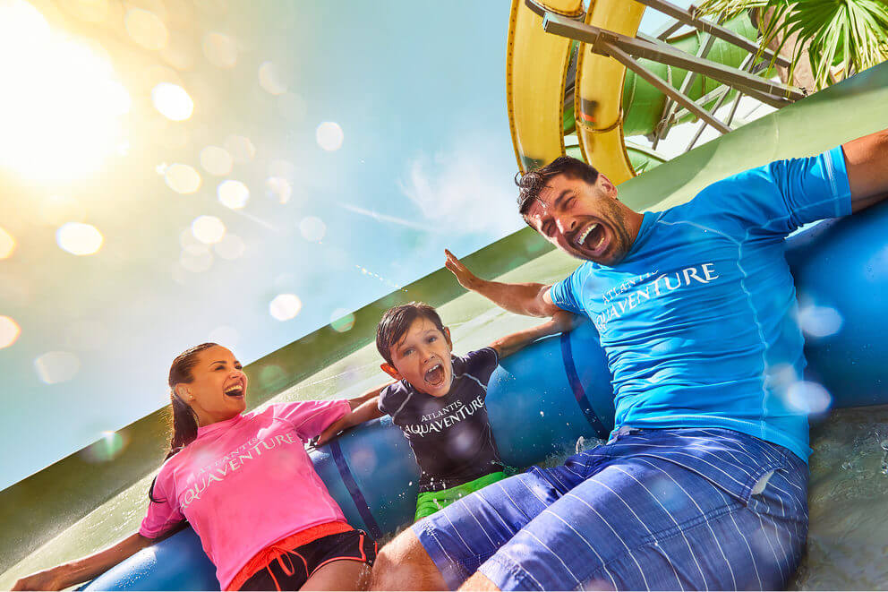 a family in a tube heading towards the pool