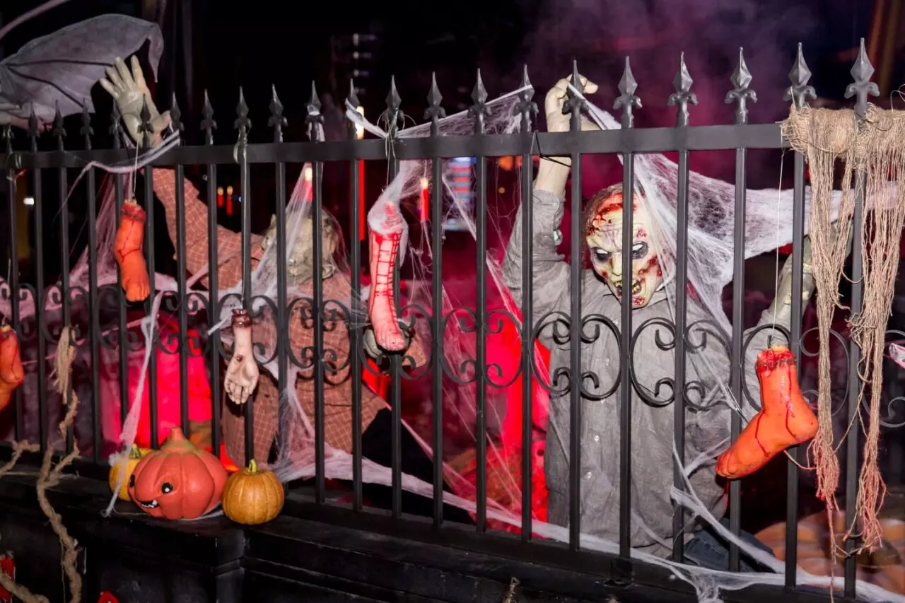 Two ghastly ghost figures looking from across the railing at IMG world of adventures