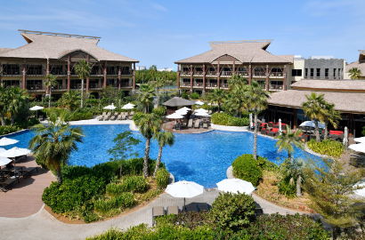 A daytime view of a hotel with a pool