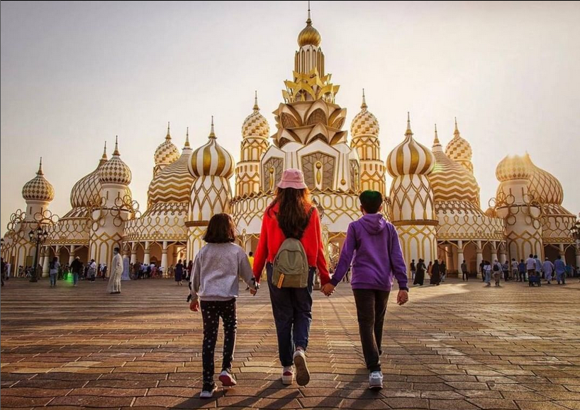 Family entering the monumental entrance of global village