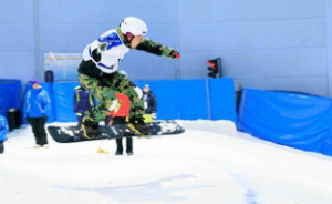 A snowboarder showcasing their skills with an impressive jump in a snow-covered landscape. 