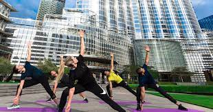women working out outdoors in front of Burj Khalifa