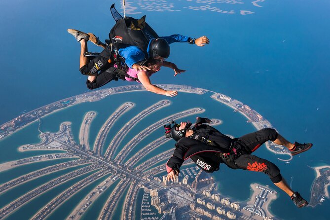 three people skydiving on the backdrop of Palm Jumeirah