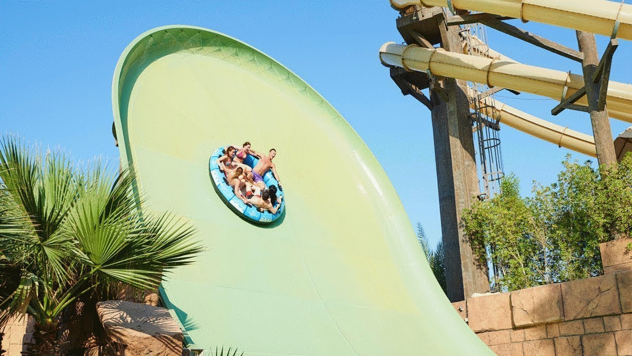 A board a six-person raft drifts like a rollercoaster on Zoomerango, which looks like a high wall in the sky